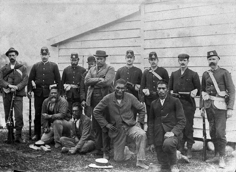 Police stand guard over five Ngāpuhi who had resisted the imposition by Hokianga County Council of a tax of 2s 6d on dogs