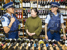 Police staff speaking with store clerk