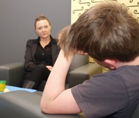 A child interviewer talking to a young boy.