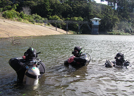Police National Dive Squad members preparing for a search of the Ross Creek Reservoir in April 2014