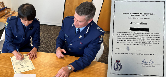 Constable Polly Yeh signing the affirmation to serve King Charles III while Police Commissioner Andrew Coster looks on.