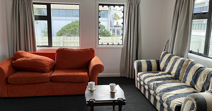 An example of staging inside the Scenario Village buildings, using furniture and household items donated by staff. A breachable window is at back centre of the photo.