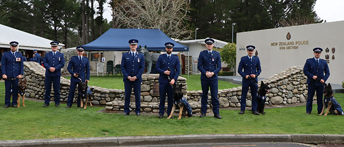 Commissioner Andrew Coster with the new dog teams. Also pictured are Inspector Todd Southall, second left, and Training Instructor Sergeant Josh Robertson, third right.
