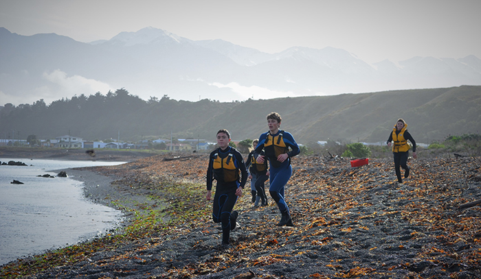 Participants running along the beach 