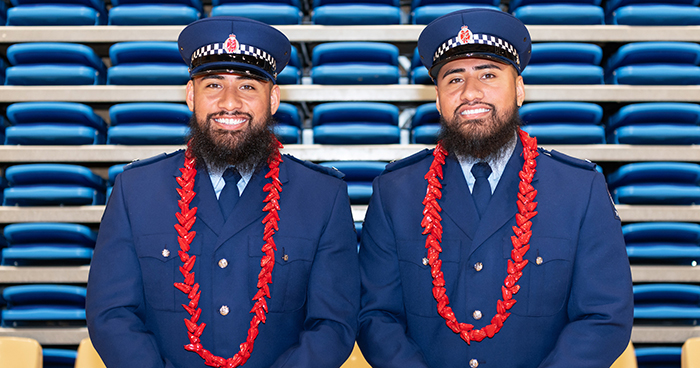 Newly graduated Constable Simala Tupuono-Pepine and his identical twin brother - and now district colleague - Leasuasu.