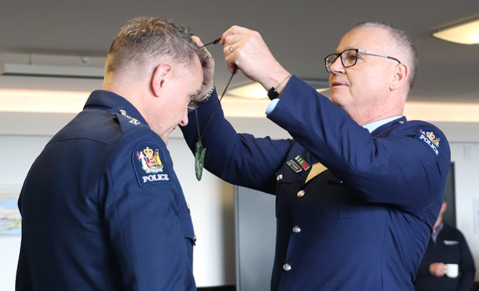  Assistant Commissioner Paul Basham handing over one of the 12 District Commander pounamu taonga to Southern District Commander Jason Guthrie.