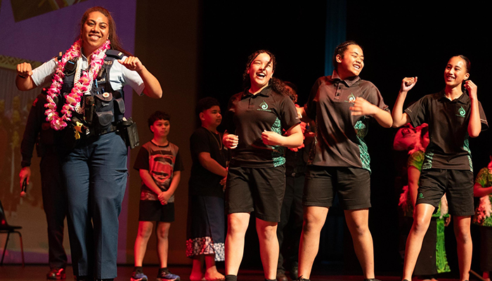Constable Penina Maisiri happily dancing with some Ross Intermediate students. PHOTO: Pasifika Fusion Festival.