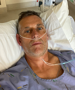 Detective Senior Sergeant Ian Foster in his hospital bed. 