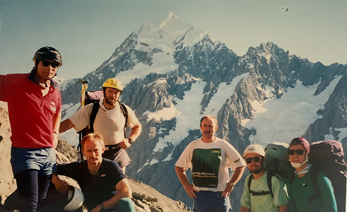 Garry in the yellow helmet with members of the Canterbury SAR team, traversing Copeland Pass with Mount Cook in the background.