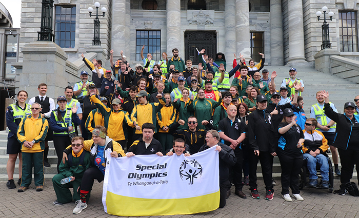 Group photo of all the special olympics athletes, Minister and Police on the steps of parliament