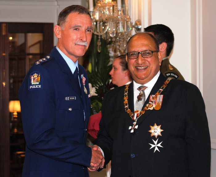 Dave shaking hands with the then Governor General, Rt Hon Sir Anand Satvanand after receiving his Queen's Service Medal.