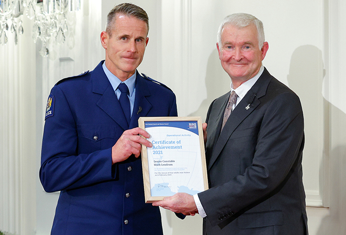 Senior Constable Mark Lendrum receiving his certificate from His Excellency Dr Richard Davies.