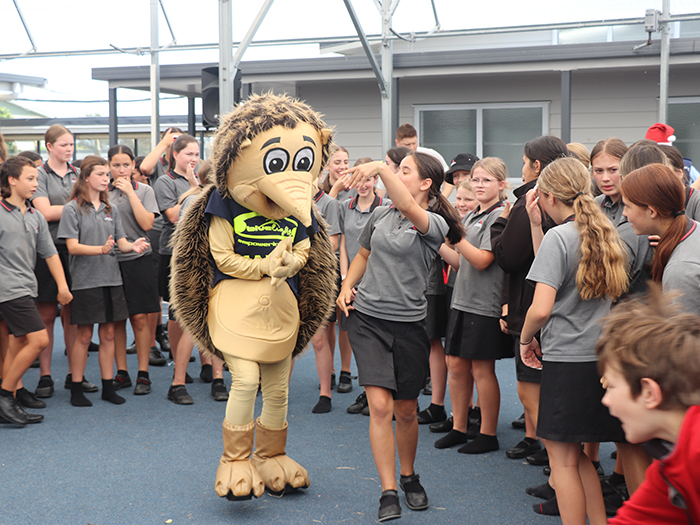 Blue Light mascot Harry the Hedgehog (Māori Warden Sharnee Miller) gets down to the beat with a Feilding Intermediate School student.