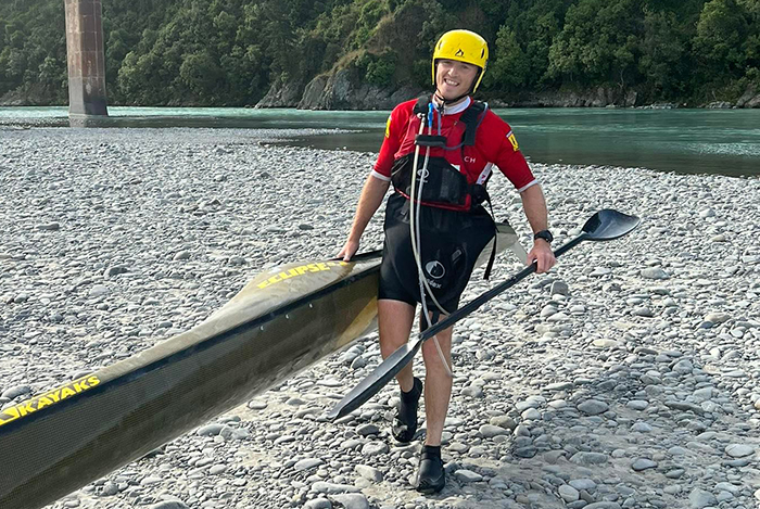 Max carrying his kayak from the water