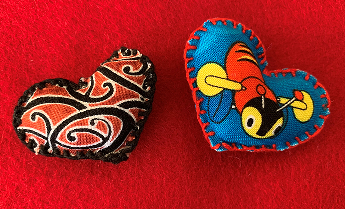 Two of Annie's handmade hearts, made with Kiwi-themed fabric.