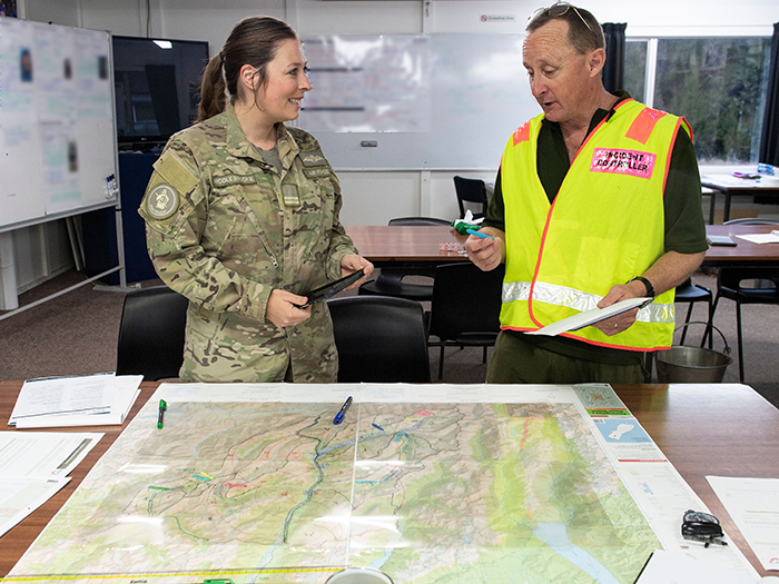 Flight Lieutenant Nicole Brooke discusses plans with a LandSAR member.