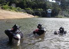 Police National Dive Squad members preparing for a search of the Ross Creek Reservoir in April 2014