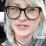 Jess wore black framed glasses