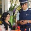 Police officer talking to a member of the community outside her business.