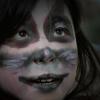 Girl's face painted for Halloween.