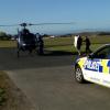 Police dog 'Gus' being carried to the helicopter that took him to Auckland