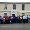 Current and former staff gather in front of the old Lyttelton police station, due to be deconstructed soon.