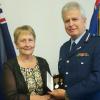Commissioner Peter Marshall presents the Meritorious Service Medal to Anne Routledge