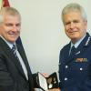 Commissioner Peter Marshall presents the Meritorious Service Medal to Detective Senior Sergeant Craig Hamilton
