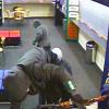 Frightening: An armed robber mounts the TAB's counter