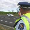 Sgt Neil Mansill points to a section of wire rope barrier which stopped a car crossing the centreline on SH1