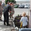 Soldiers and a police officer receive an extra pair of helping hands