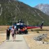 Rescued hiker (dressed in black) being escorted to Aoraki Mt Cook Emergency Centre