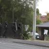 Members of the Waikato Armed Offenders Squad approach an Ellicott Rd address