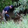 Police searching the area near where Friday's murder occurred describe the terrain as challenging