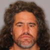 Darren Millar has a warrant for his arrest on assault charges