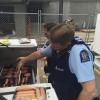 Senior Sergeant Mike Stevenson multi-tasks, taking a call while manning the BBQ.