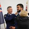 Commissioner Mike Bush and Carolyn Tremain change Wing 319 Constable Richard Paku's epaulettes from recruit to constable