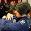 Two new constables embrace after taking their oath on Tuesday