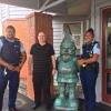 Constable Iosefo Pasina (left), a Salvation Army staff member, and Constable Ngametua Meti with the recovered gnome statue