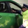 A police officer speaks to a motorist at a checkpoint. 