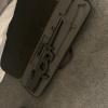 A prohibited firearm in a black case which was recovered during a search warrant. 