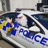 Blue Santa driving a police car