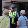 Sergeant Philip Rowden speaks with two tourists in Napier CBD