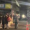 Tourists outside hostel as emergency services respond to fire.