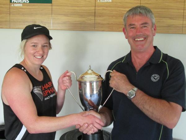 Organiser Tony Maw presents the Division 1 trophy to the PST captain Kat Hose. Photo: Bruce Cosgrove.