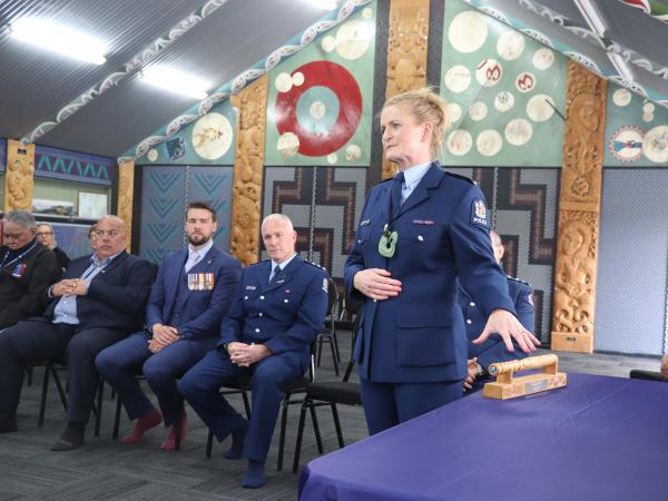 Superintendent Jeanette Park speaks of the significance of the District Commander baton passed to her at today's pōwhiri  