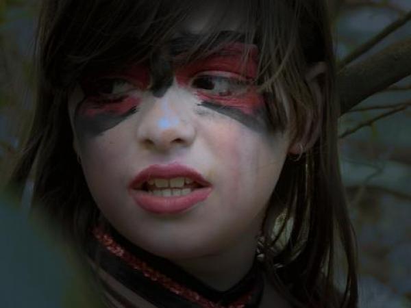 Girl's face painted for Halloween.