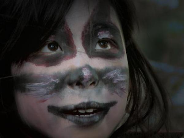 Girl's face painted for Halloween.