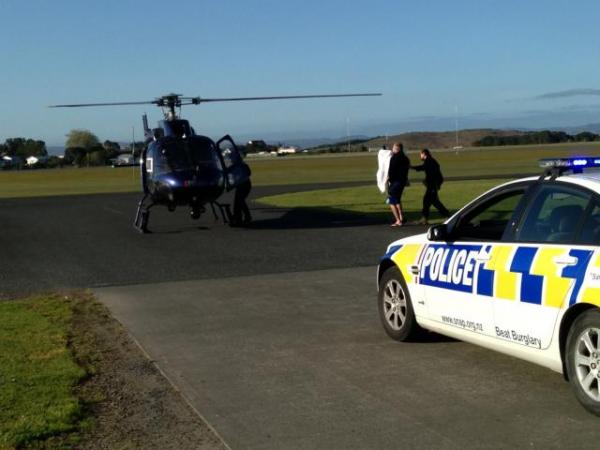 Police dog 'Gus' being carried to the helicopter that took him to Auckland