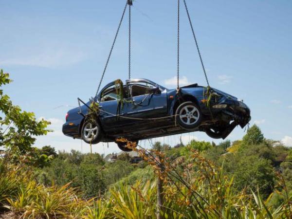 HIGH BUT NOT DRY; the car as it is lifted from the Waikato River